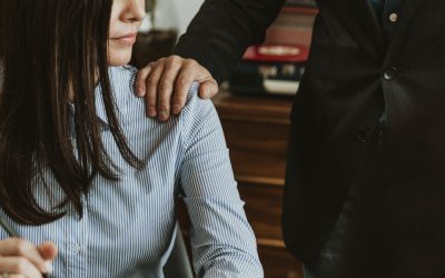 Businessman patting a colleague on her shoulder